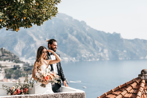 Bride and groom looking out to sea on the Amalfi coast on their elopement wedding day