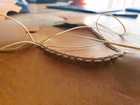 Hand stitching the apron on a handmade apron derby