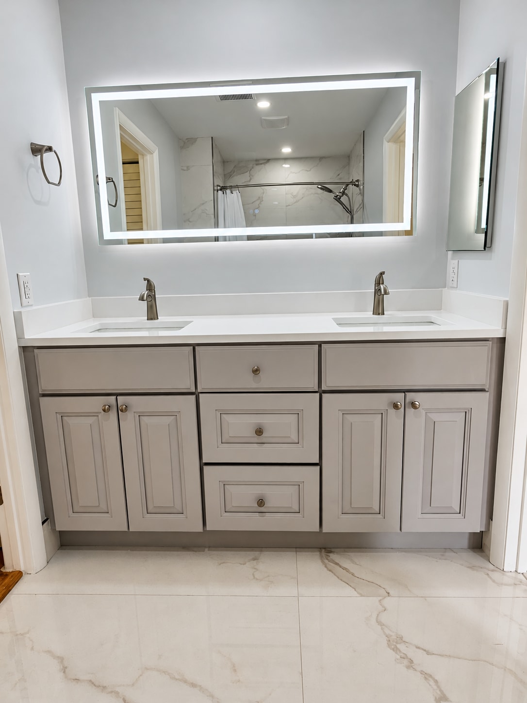 Gray vanity & marble tub bathroom