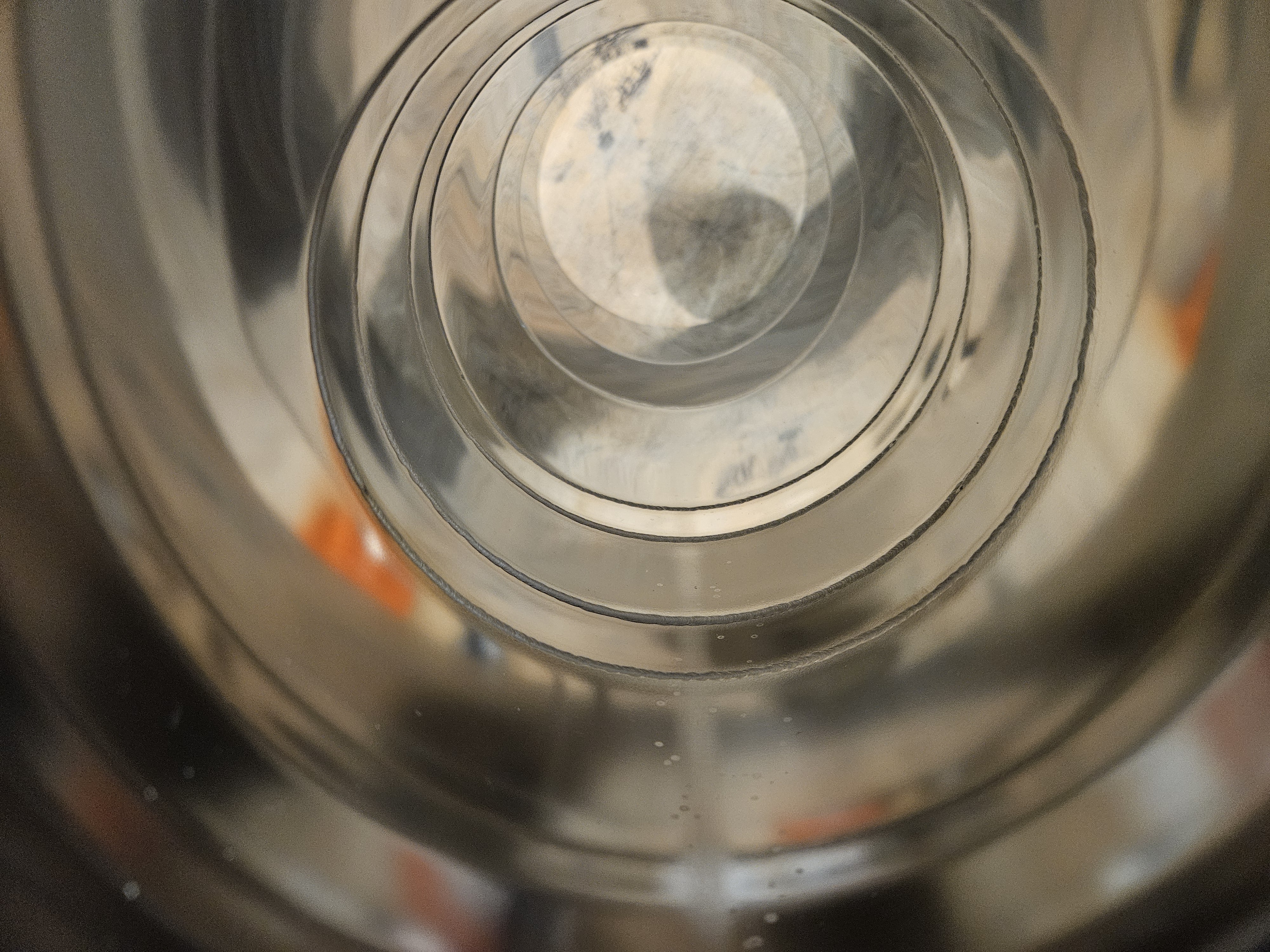 Close view inside metal tubing showing multiple circumferential welds