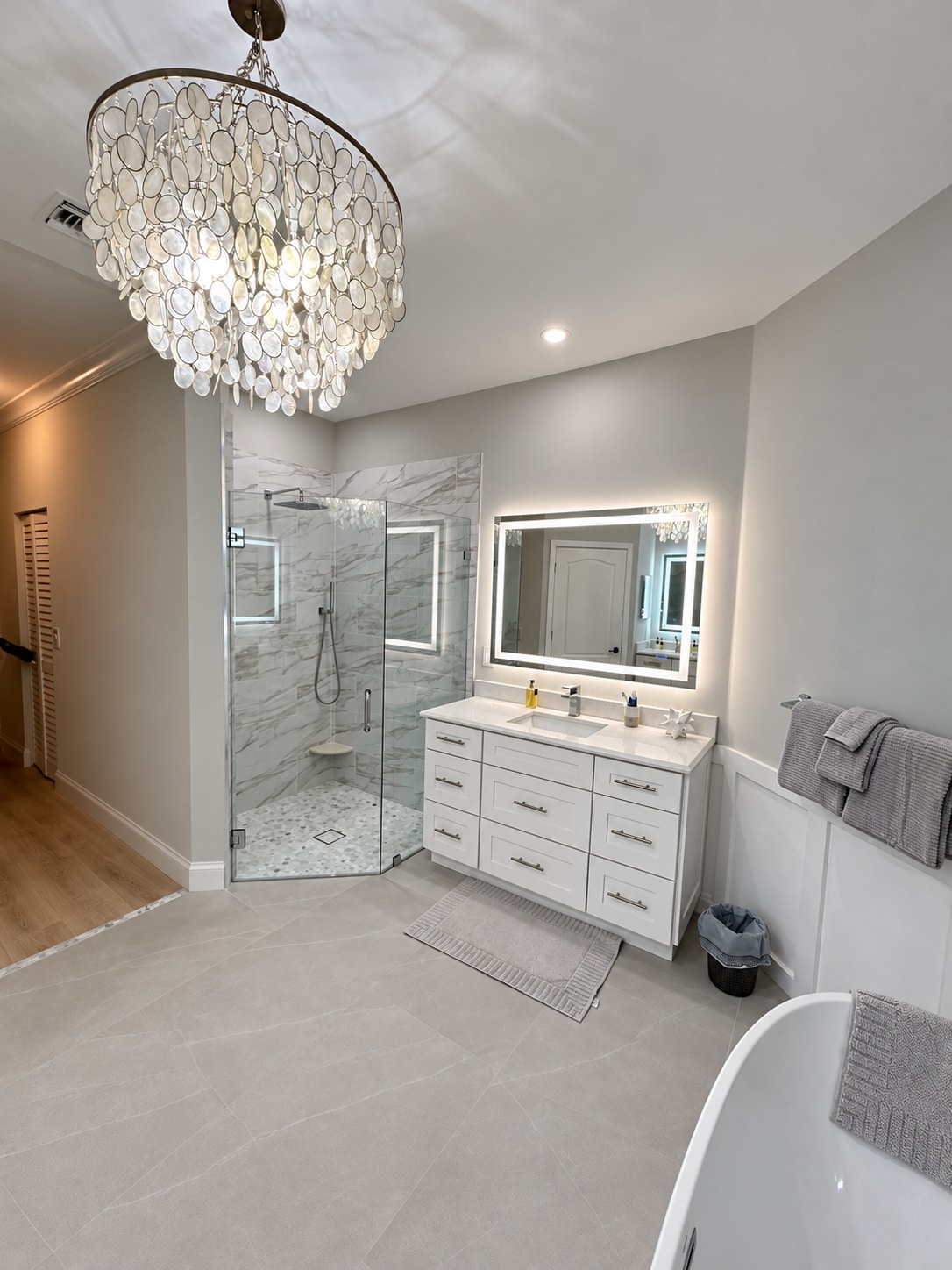 Chandelier & glass shower bathroom