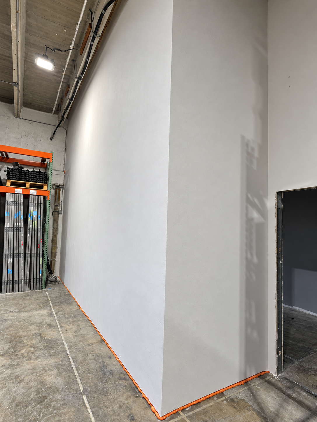 Office expansion in progress showing a newly built interior partition and doorway