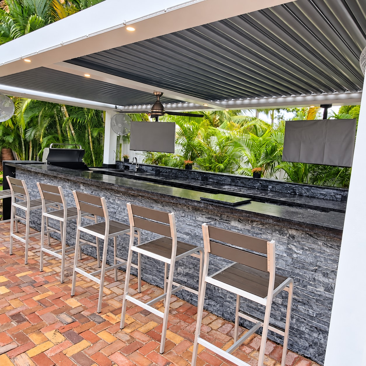 Covered outdoor kitchen & stone bar