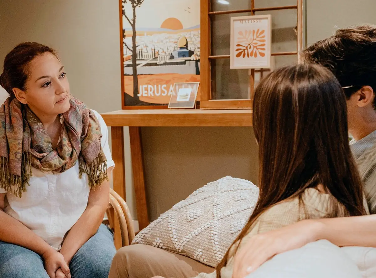 A couples therapy conversation in a warm, welcoming office
