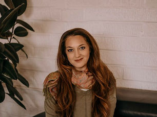 Shira Hearn seated in her practice, Radical Relationship Transformation