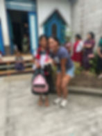 Carlee & one of the sweeties at Ninos receiving their backpacks.