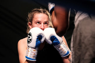 A female boxer staring at her oppenent.