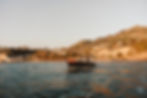 Ischia luxury charter boat cruising near the coastline.