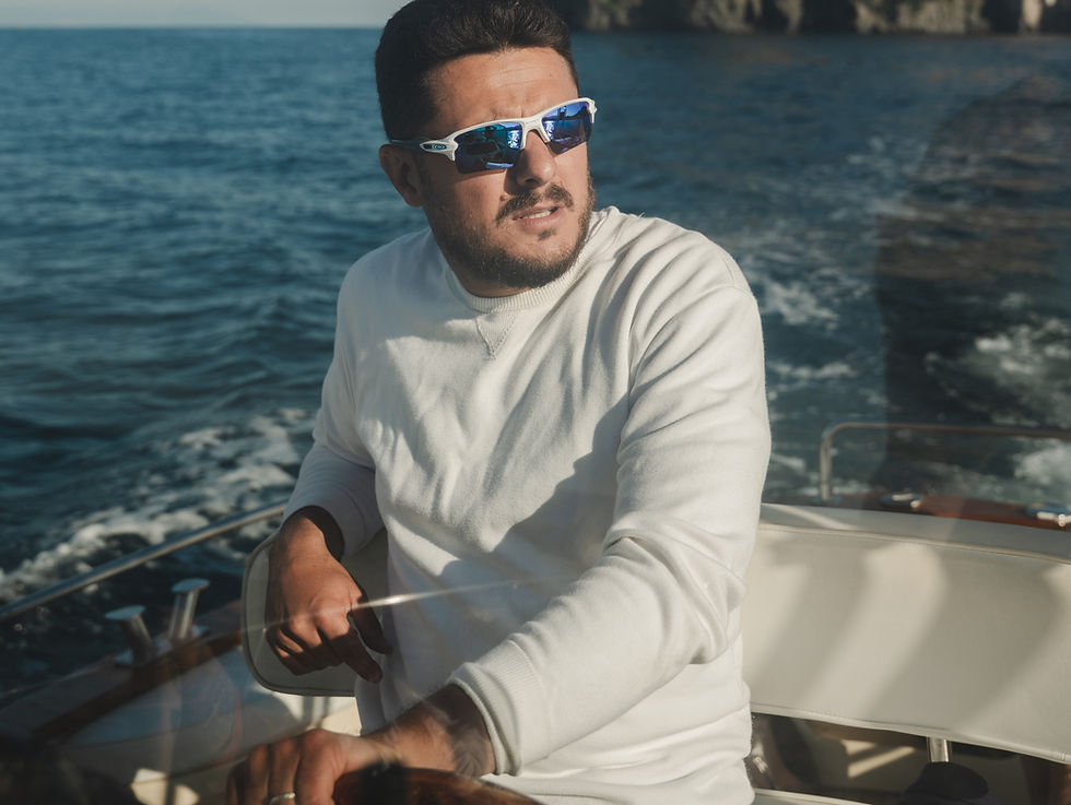 Renato piloting an Ischia luxury charter near the castle.