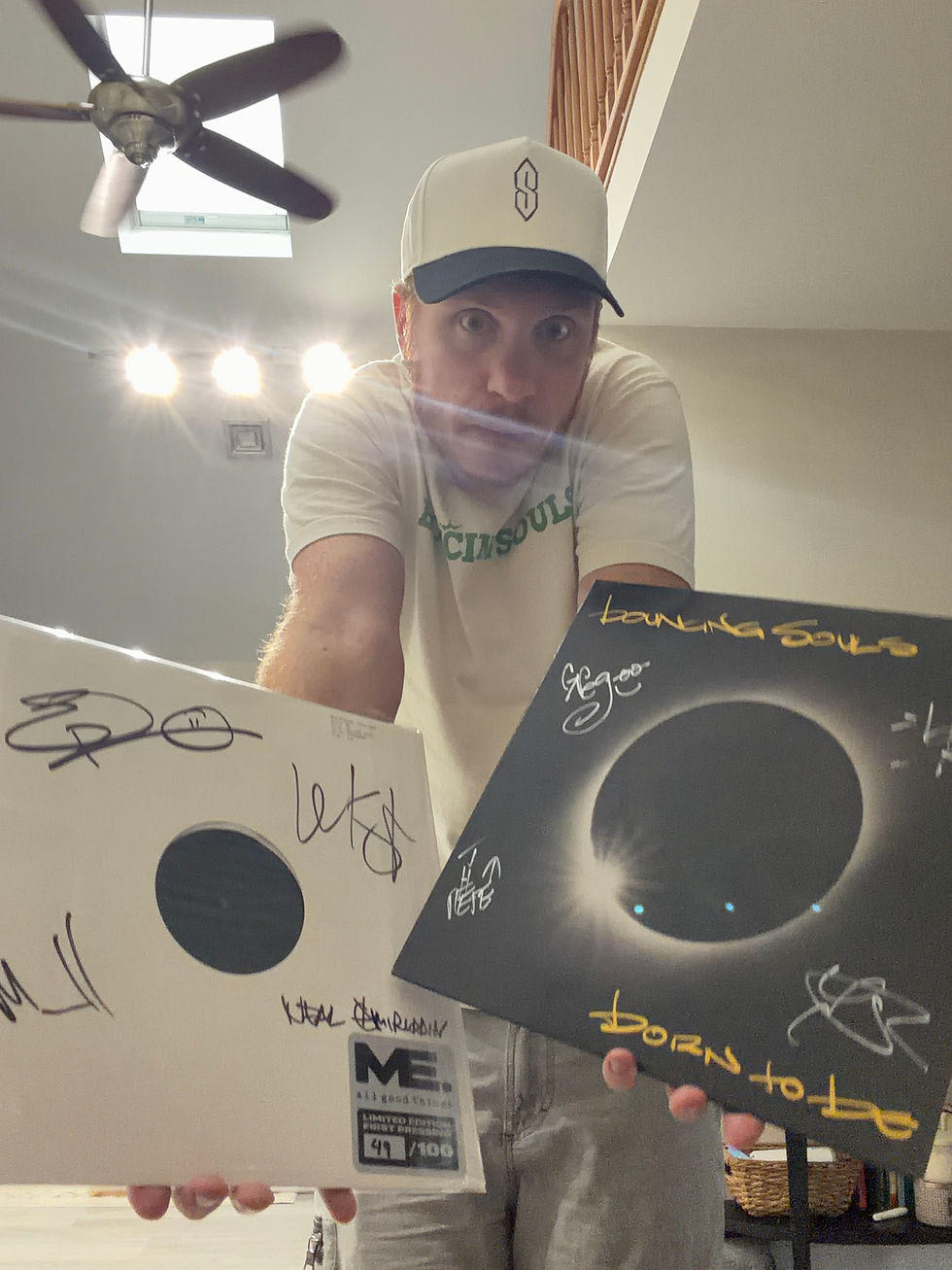 Winner of the Riot + Reverie Six-Month Archive Drop, posing with records from the giveaway.