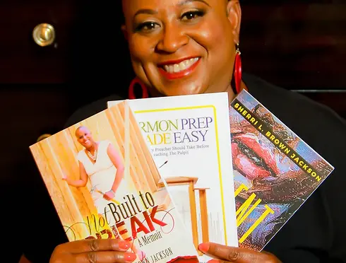 Sherri Jackson holding books she wrote