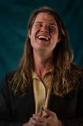 Nate throws head back, looks to the side and laughs