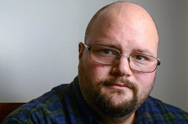 Sam - glasses and beard with neutral shadowed background