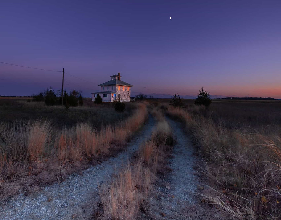 Pink House of Newbury, MA at night with a half moon