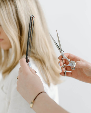 Hair stylist with scissors and comb