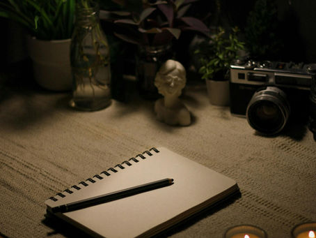 desk with candles and a journal