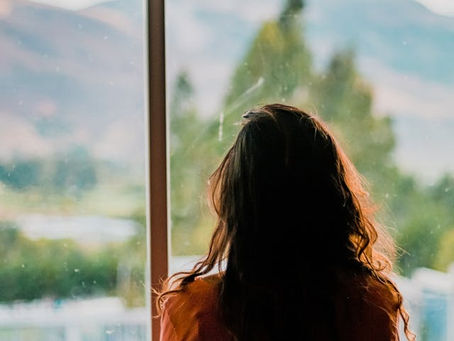 woman looking out a window