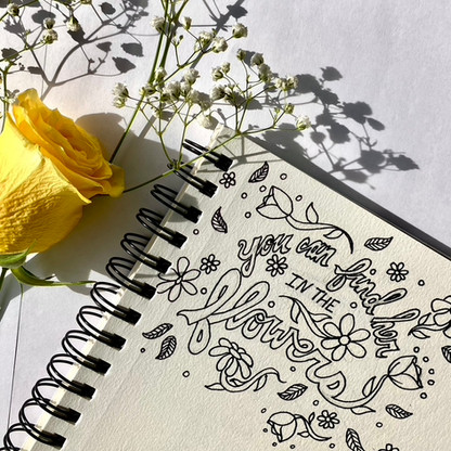Ariana Lee Creative sketchbook page of hand lettering that says "You can find her in the flowers"