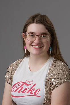 Student standing in front of rock with Weber State W