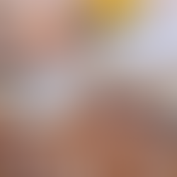 a wooden tray with a bottle of water next to two glasses, a large serving tray with fresh berries, mango, and sliced grapefruit, a stack of clay plates topped with lemons, and a pair of sunglasses and an addition of vogue on a burlap pillow, all set on a patterned tan rug