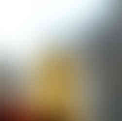 a hand holds up a segment of citrus fruit in front of a light