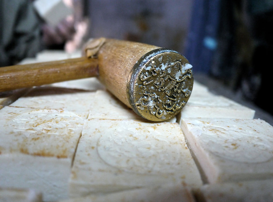a close up of the mallet used to impress the soap. you can faintly see the camel emblem