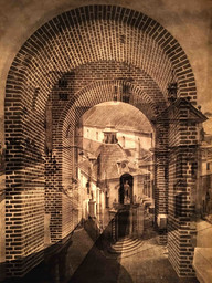 a photograph of two overlapping images (one of a brick archway, one an aerial photo of a European building)
