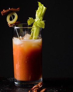 a bloody mary against a black background
