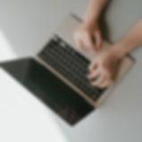 Angelie Rasmussen, The Copy Creative, typing creative copy on her laptop. Hands are typing, only the laptop and hands are seen