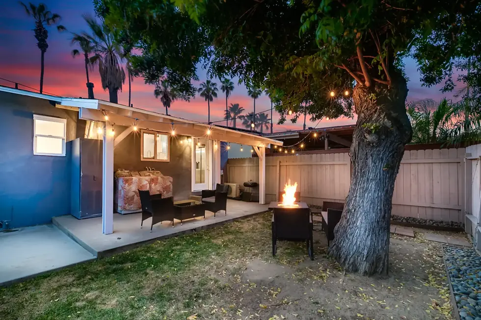 Modern San Diego patio with fire pit and string lights showcasing outdoor living space for property management compliance