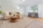 Modern living room with cream sectional and natural light in a San Diego vacation rental
