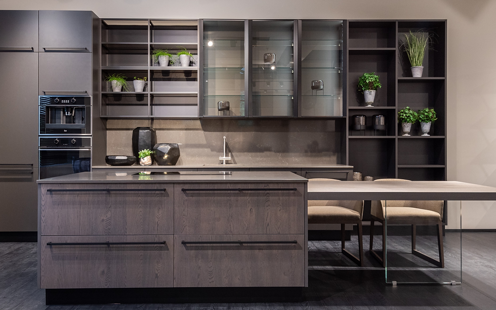Modern kitchen with dark cabinets, built-in oven, and gray island. Ready to be lived-in.