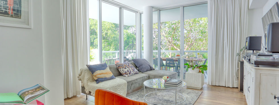 Open living area with balcony access and contemporary furniture at IOS on the Bay 310 Miami