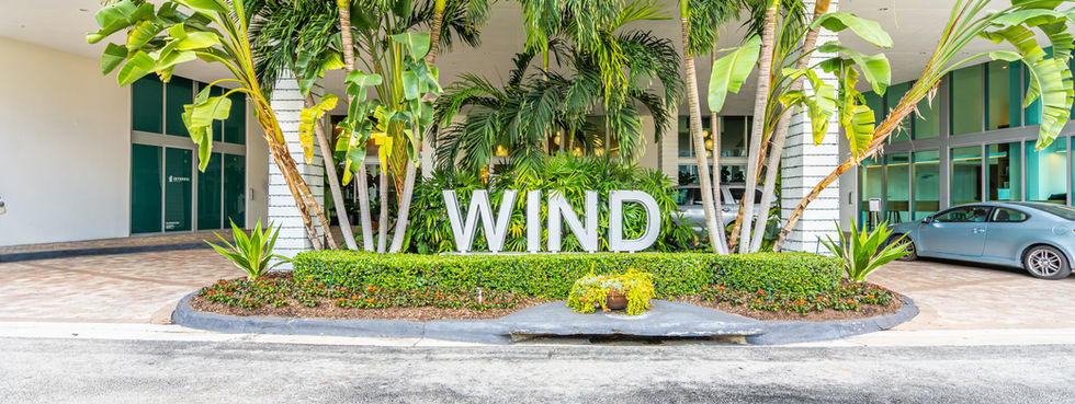 Wind Brickell building entrance palm trees tropical landscaping Miami