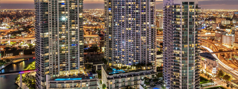 Wind Brickell tower aerial dusk view Miami River city skyline