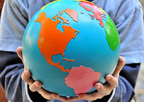 Montessori Child holding the Globe of Continents