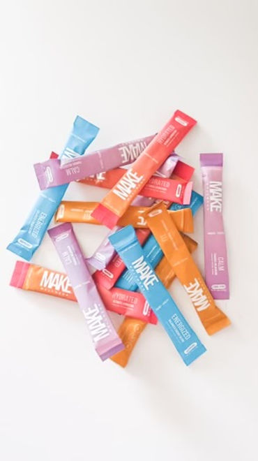 Colorful assortment of MAKE Wellness peptide supplement packets