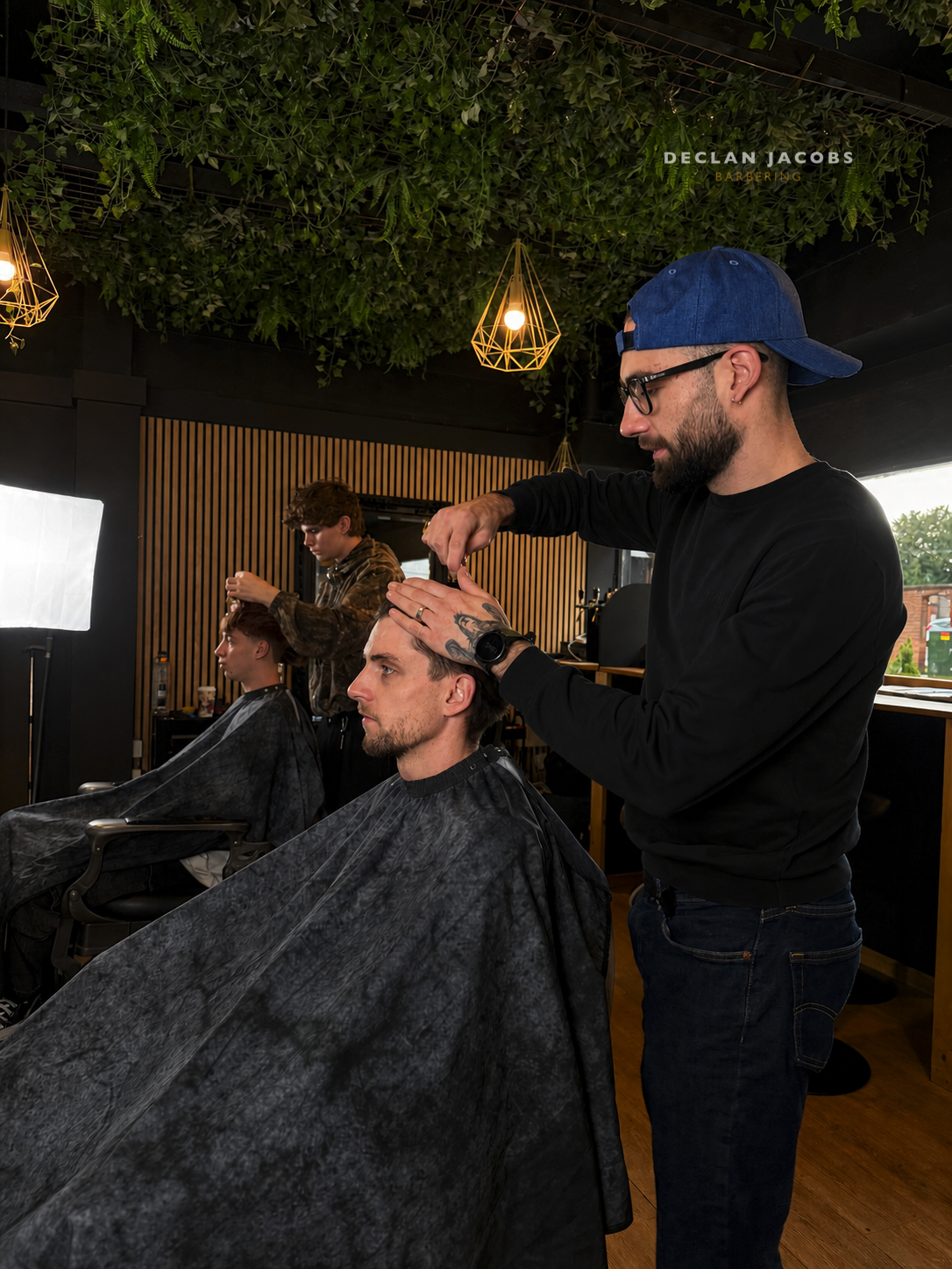 A DJB barber cutting a client's hair at Declan Jacobs Barbering in Bromsgrove
