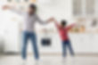 cute-black-father-and-daughter-dancing-at-kitchen-2022-02-17-02-29-20-utc.jpg