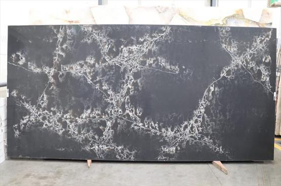 COMPAC Ice Black engineered stone surface with a deep charcoal-black surface with striking pale veining and warmer mineral accents