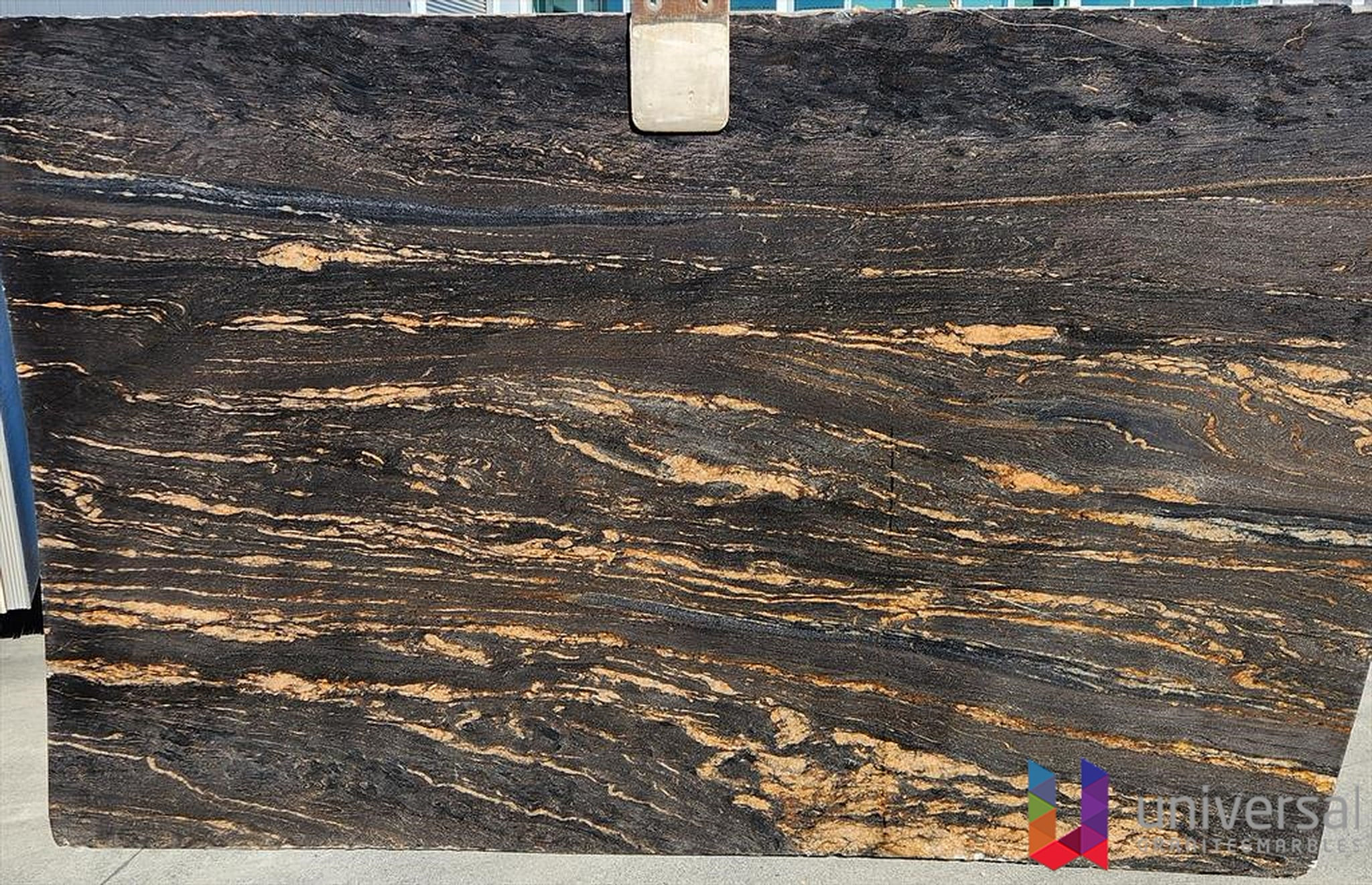 Titanium Gold Platinum black granite slab with bold silvery-white mineral areas and subtle warm gold detail.