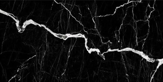 UniCeramica Maquina porcelain stone surface with a rich black surface with bold white marble-style veining