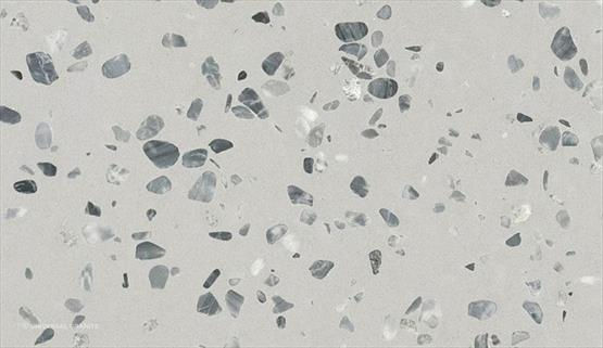 COMPAC Petra Nublo engineered stone surface with a pale grey terrazzo-style base with contrasting charcoal, white and mid-grey fragments
