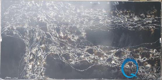 COMPAC Ice Max Black engineered stone surface with a rich black base layered with sweeping white and warm-gold marble-style veining