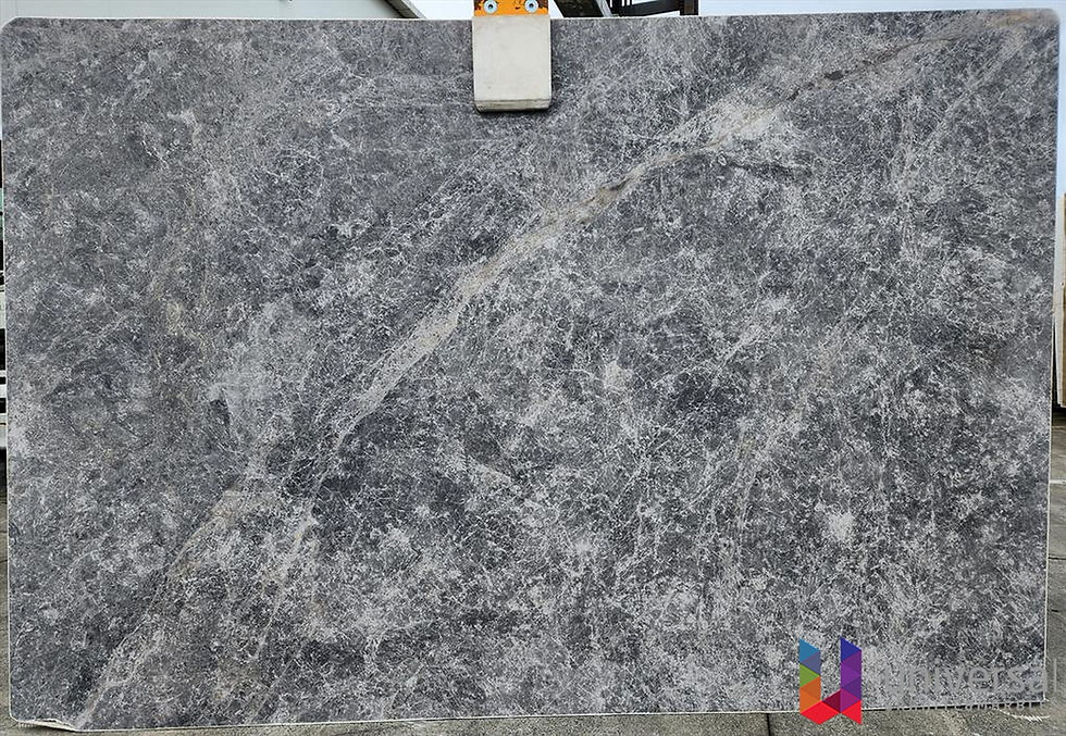 Tundra Grey Deluxe soft mid-grey marble slab with fine pale veining and gentle clouded variation.