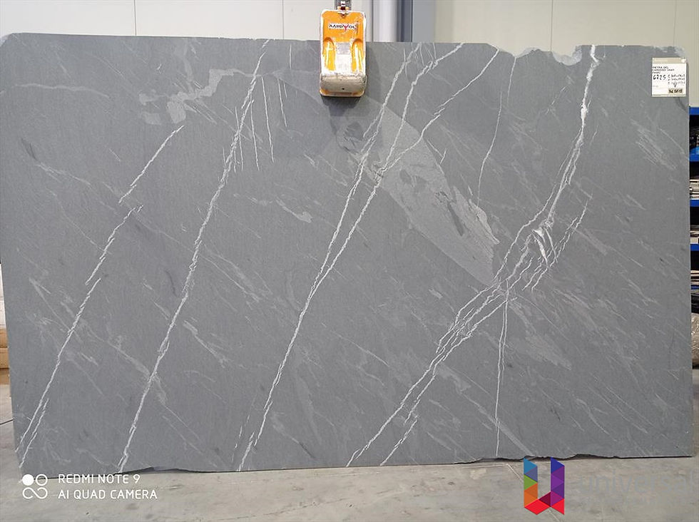 Pietra Cardoso Elite deep grey marble slab with fine white diagonal mineral lines.