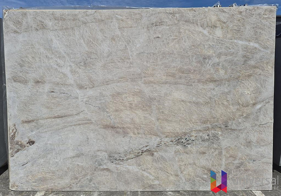 Taj Mahal Platinum creamy white quartzite slab with warm beige undertones and gentle flowing movement.
