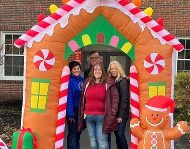 Individuals under an inflatable gingerbread arch