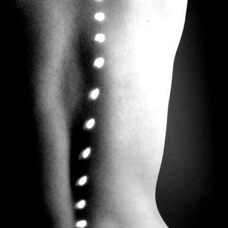 Sensual light. Shuttered light flowing naturally down her spine