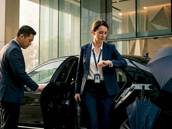 Executive arriving at office with chauffeur